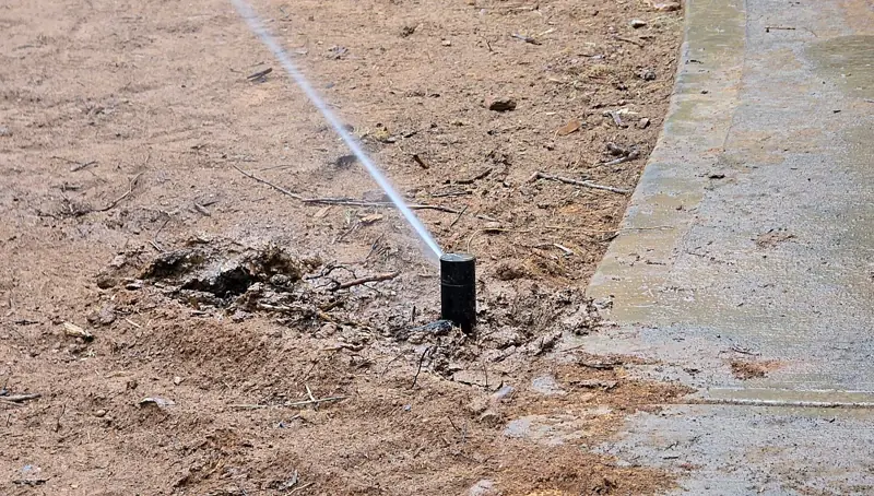 Close-up of a pop-up rotor sprinkler head running
